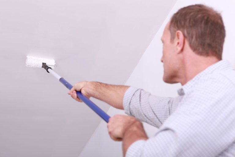 What causes recurring paint failures inside buildings